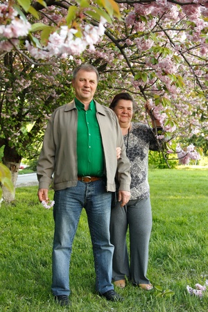 11533542 - mature couple cheerful hug in spring garden